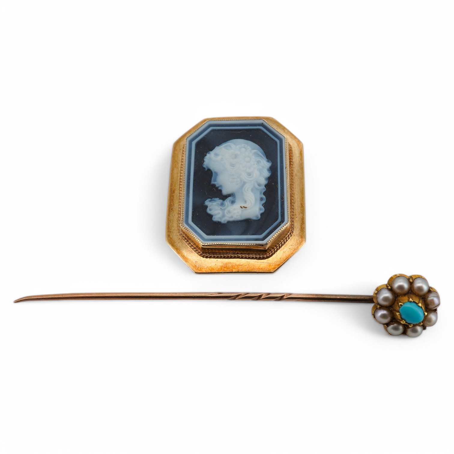 A 20th century yellow metal mounted cameo jasper ceramic octagonal brooch, 31mm, together with an early 20th century yellow metal and gem set stick pin, gross weight 9.3 grams. Condition - poor to fair